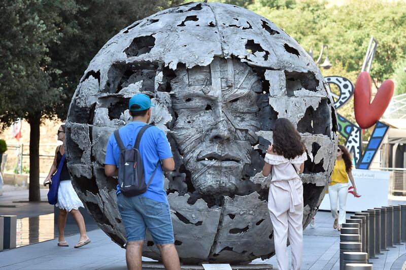 People look at an artwork by Lebanese sculptor Bassam Kyrillos called 'Equinox' at Beirut Art Week in Lebanon. EPA