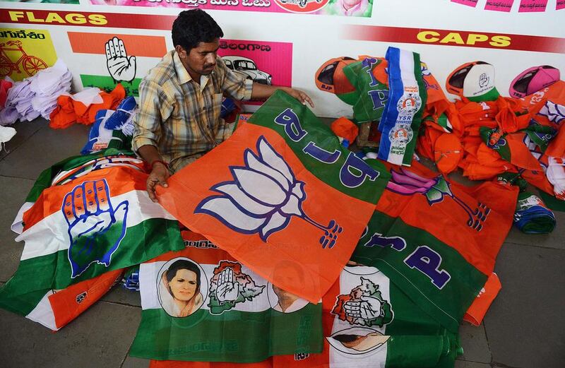 A worker folds and separates campaign flags for different political parties at a workshop in Hyderabad. Politicians are expected to spend as much as US$5 billion on campaigning for the multi-stage general election that begins on April 7. Noah Seelam /AFP / March 7, 2014

