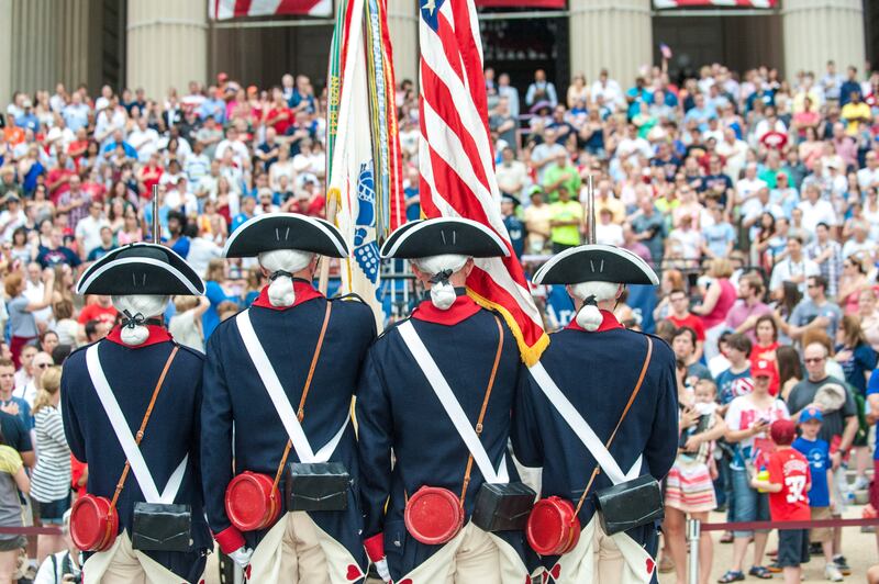 Role players recreate a scene from 1776 for an audience outside Washington's National Archives. Photo: US National Archives