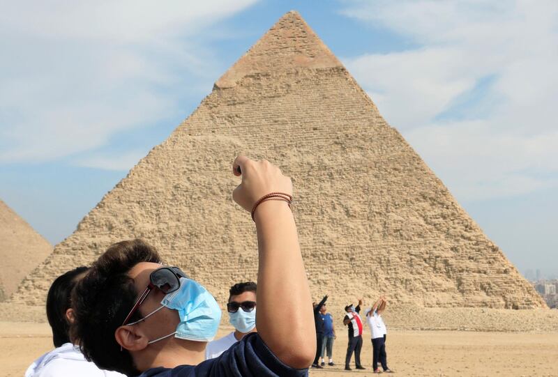 Tourists are seen in front of the pyramid of Khafre or "Chefren" in Giza, Egypt. Reuters