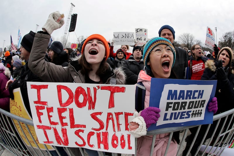 Demonstrators hold signs at the 2018 March for Our Lives rally in Chicago. AP