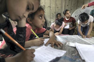 Children attend an Arabic language lesson given by a Palestinian school girl Fajr Hmaid, 13, as schools are shut due to the coronavirus disease (COVID-19) restrictions, at Hmaid's family house  in Gaza City,June 4, 2020.
 (Photo by Majdi Fathi/NurPhoto via Getty Images)