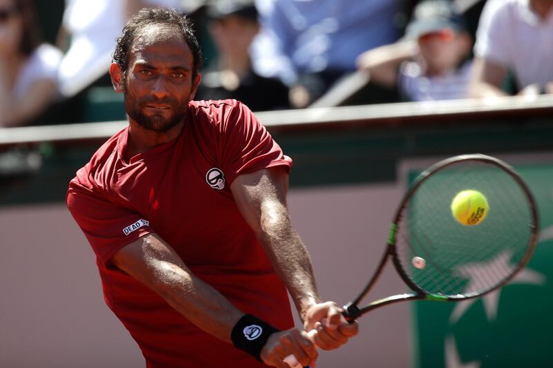 Egypt's Mohamed Safwat returns the ball to Bulgaria's Grigor Dimitrov during their first round match of the French Open tennis tournament at the Roland Garros Stadium, Sunday, May 27, 2018 in Paris. (AP Photo/Alessandra Tarantino)