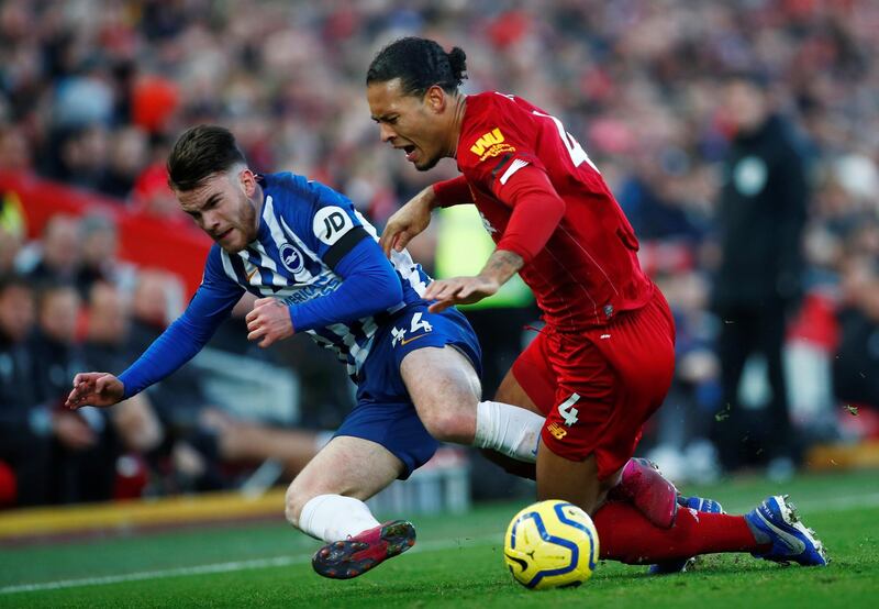 Liverpool's Virgil van Dijk in action with Brighton's Aaron Connolly. Reuters