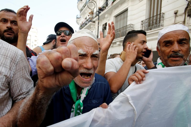 Demonstrators gesture during a protest opposing the election that Algeria's veteran ruling cadre has set for December, in Algiers, Algeria. Reuters