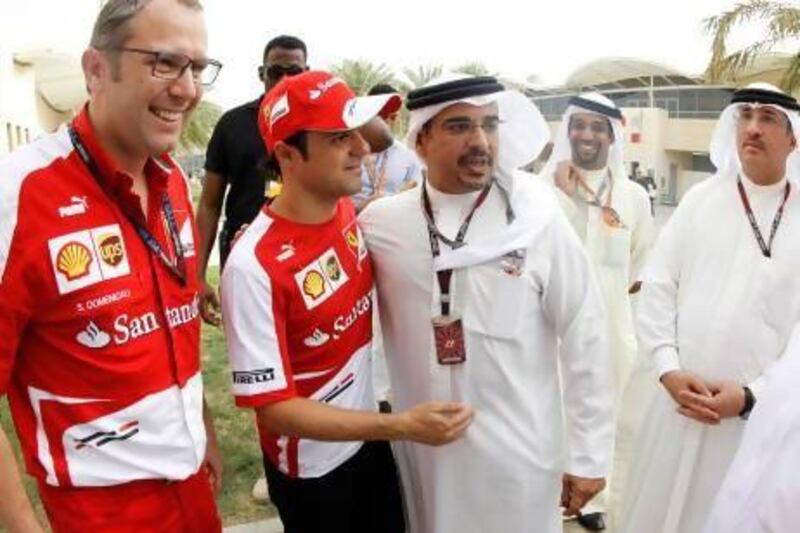 Bahrain's Crown Prince Salman bin Hamad bin Isa Al Khalifa speaks to the driver Felipe Massa after the qualifying session for the Bahrain F1 Grand Prix at the Sakhir circuit on Saturday. Hamad I Mohammed / Reuters