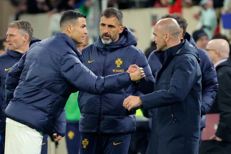 Portugal's Cristiano Ronaldo, left, shakes hands with coach Roberto Martinez at the final whistle. AP