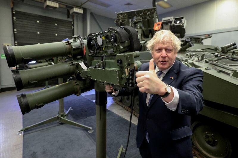 British Prime Minister Boris Johnson gives the thumbs-up next to a Mark 3 shoulder-launch LML missile system as he visits Thales weapons manufacturer during a visit to Northern Ireland for talks with Stormont parties, in Belfast on Monday. Reuters