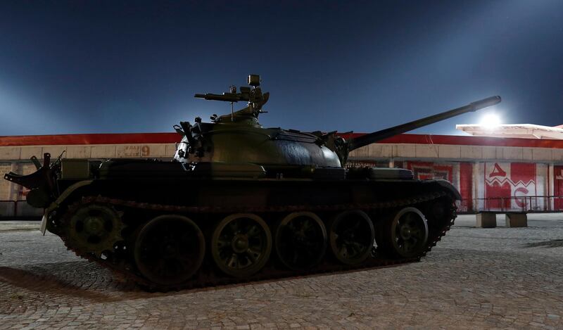 A Red Star Belgrade fan stands on the Soviet-made T-55 main battle tank in front of Rajko Mitic stadium. AP Photo