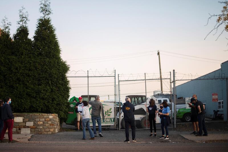 Visitors gather outside Four Seasons Landscaping. Reuters