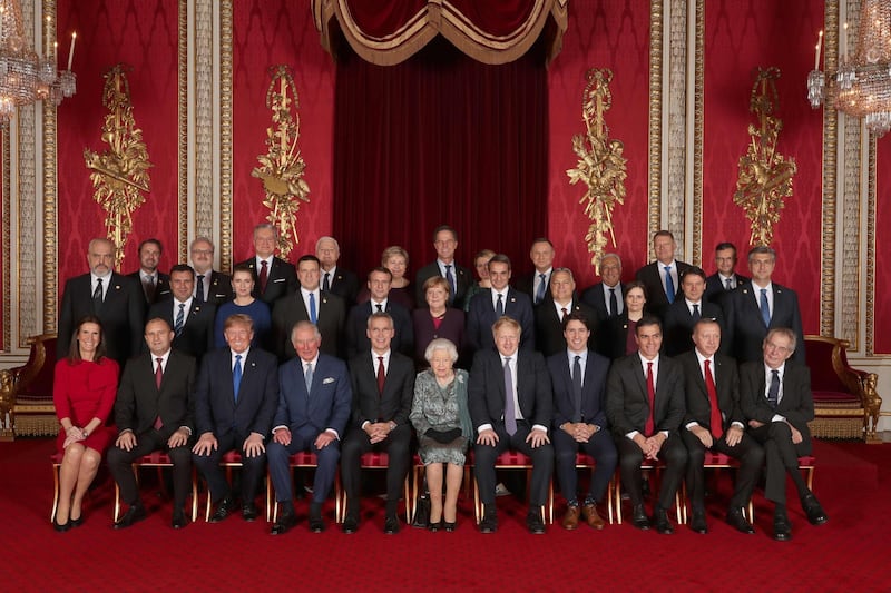 TOPSHOT - Leaders of Nato alliance countries, and its secretary general, join Queen Elizabeth II and the Prince of Wales for a group picture to mark 70 years of the alliance. Back row, from left: Xavier Bettel, Prime Minister of Luxembourg; Egils Levits, President of Latvia; Gitanas Nauseda, President of Lithuania; Dusko Markovic, Prime Minister of Montenegro; Erna Solberg, Prime Minister of Norway; Mark Rutte, Prime Minister of Netherlands; Zuzana Caputova, President of Slovakia; Andrzej Duda, President of Poland; Antonio Costa, Prime Minister of Portugal; Klaus Iohannis, President of Romania; Marjan Sarec, Prime Minister of Slovenia.  Middle row from left: Edi Rama, Prime Minister of Albania; Zoran Zaev, Prime Minister of North Macedonia; Mette Frederiksen, Prime Minister of Denmark; Juri Ratas, Prime Minister of Estonia; Emmanuel Macron, President of France; Angela Merkel, President of Germany; Kyriakos Mitsotakis, Prime Minister of Greece; Viktor Orban, Prime Minister of Hungary; Katrin Jakobsdottir, Prime Minister of Iceland; Giuseppe Conte, Prime Minister of Italy; Andrej Plenkovic, Prime Minister of Croatia.  Seated from left: Sophie Wilmas, Prime Minister of Belgium; Rumen Radev, President of Bulgaria; Donald Trump, President of United States; The Prince of Wales; Jens Stoltenberg, Nato Secretary General; Queen Elizabeth II; Boris Johnson, Prime Minister of the United Kingdom; Justin Trudeau, Prime Minister of Canada; Pedro Sanchez, Acting Prime Minister of Spain; Recep Tayyip Erdogan, President of Turkey; Milos Zeman, President of the Czech Republic pose together at Buckingham Palace in central London on December 3, 2019, during a reception hosted by Britain's Queen Elizabeth II ahead of the NATO alliance summit. NATO leaders gather Tuesday for a summit to mark the alliance's 70th anniversary but with leaders feuding and name-calling over money and strategy, the mood is far from festive. / AFP / POOL / Yui Mok
