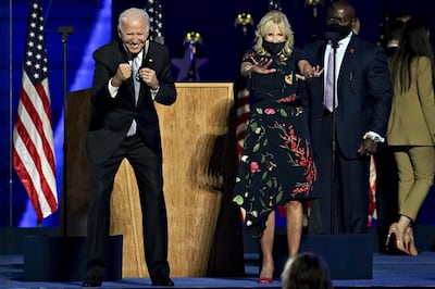 U.S. President-elect Joe Biden, left, and wife Jill Biden gesture to the audience during an election event in Wilmington, Delaware, U.S., on Saturday, Nov. 7, 2020. Biden defeated Donald Trump to become the 46th U.S. president, unseating the incumbent with a pledge to unify and mend a nation reeling from a worsening pandemic, faltering economy and deep political divisions. Photographer: Sarah Silbiger/Bloomberg