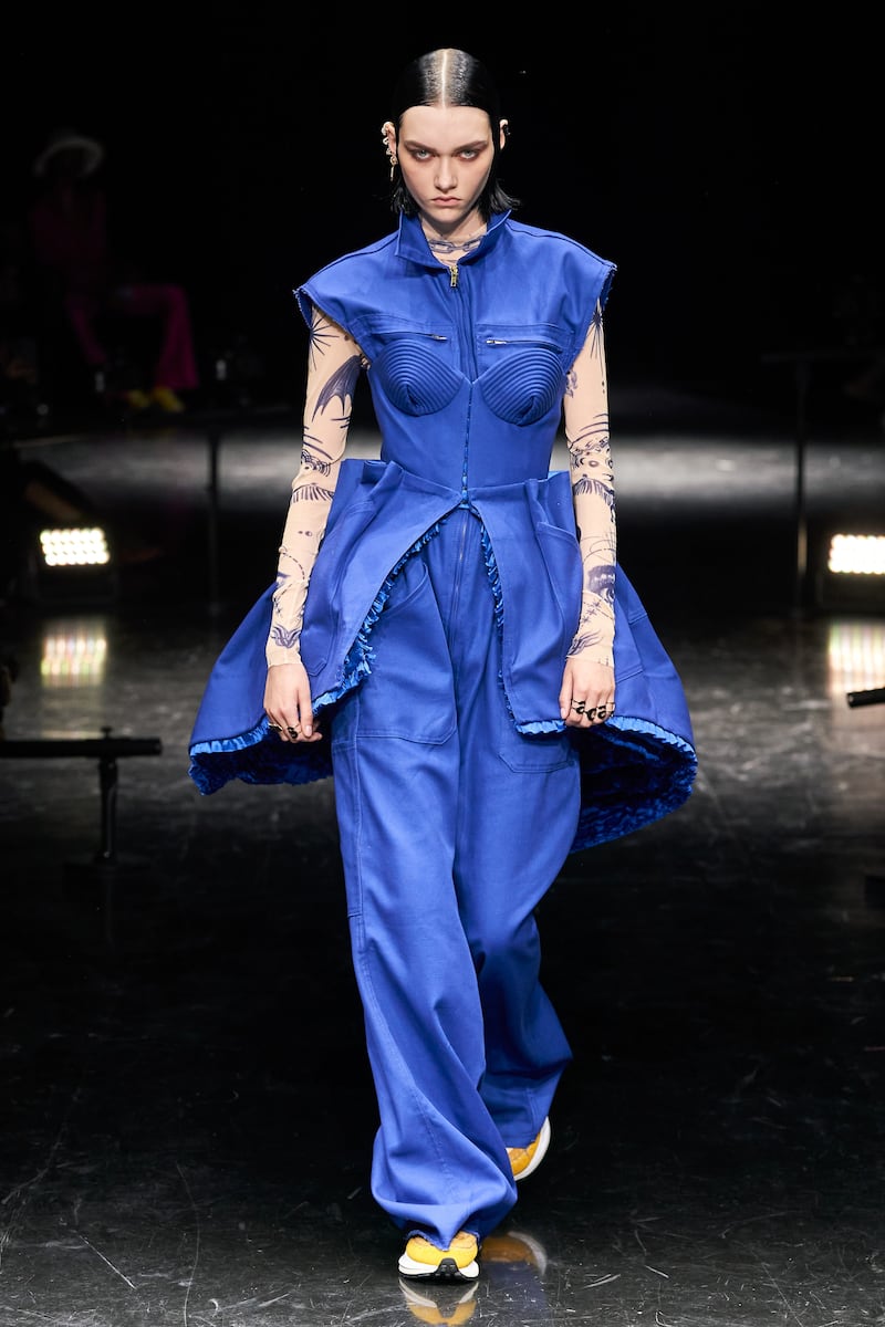 A utilitarian jumpsuit is elevated with a corseted dress at Jean Paul Gaultier.