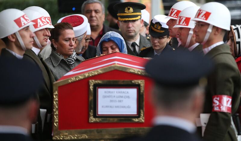 epa06515125 Turkish soldiers salute as Fatma Karaca (back-C), mother of Koray Karaca, a Turkish soldier who was killed in cross-border clashes with Kurdish Popular Protection Units (YPG) forces at Afrin, mourns near by his coffin during a funeral ceremony in Istanbul, Turkey 11 February 2018. The Turkish army is on an operation named 'Operation Olive Branch' in Syria's northern regions against the Kurdish Popular Protection Units (YPG) forces which control the city of Afrin. Turkey classifies the YPG as a terrorist organization. At least 32 Turkish soldiers were killed and over 100 were injured during the operation.  EPA/ERDEM SAHIN