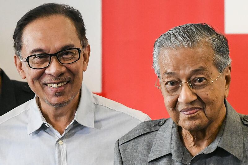 (FILES) In this file photo taken on June 1, 2018, Malaysia's Prime Minister Mahathir Mohamad (R) and politician Anwar Ibrahim leave after a press conference in Kuala Lumpur. Malaysian politics was in turmoil on February 24, 2020 after leader-in-waiting Anwar Ibrahim denounced a "betrayal" by coalition partners he said were trying to bring down the government, two years after it stormed to victory. / AFP / Mohd RASFAN
