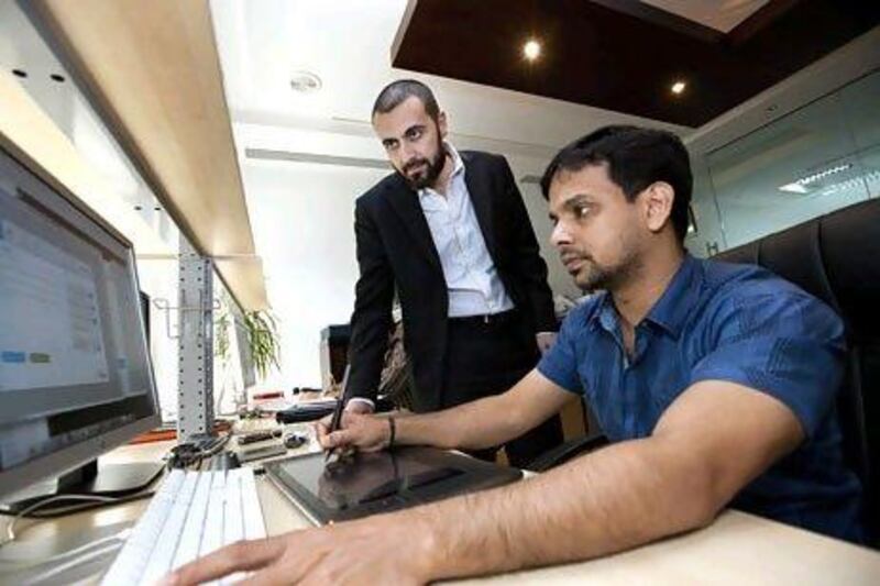 Shadi Al Hasan, left, the managing director of Flagship Projects, helps develop apps for companies.