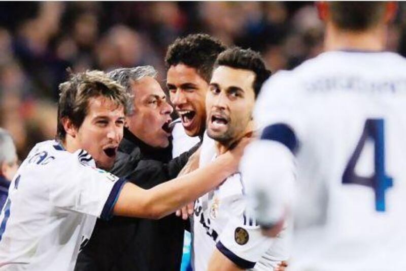 Jose Mourinho celebrates with the Real Madrid players after their win over Barcelona. David Ramos / Getty Images