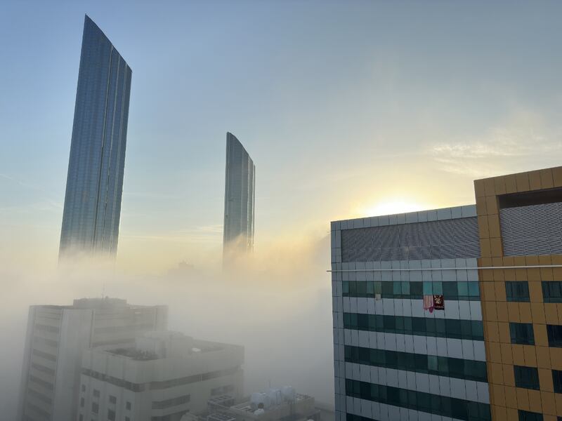 Thick fog covers the Abu Dhabi skyline near the World Trade Centre on Tuesday morning. The National