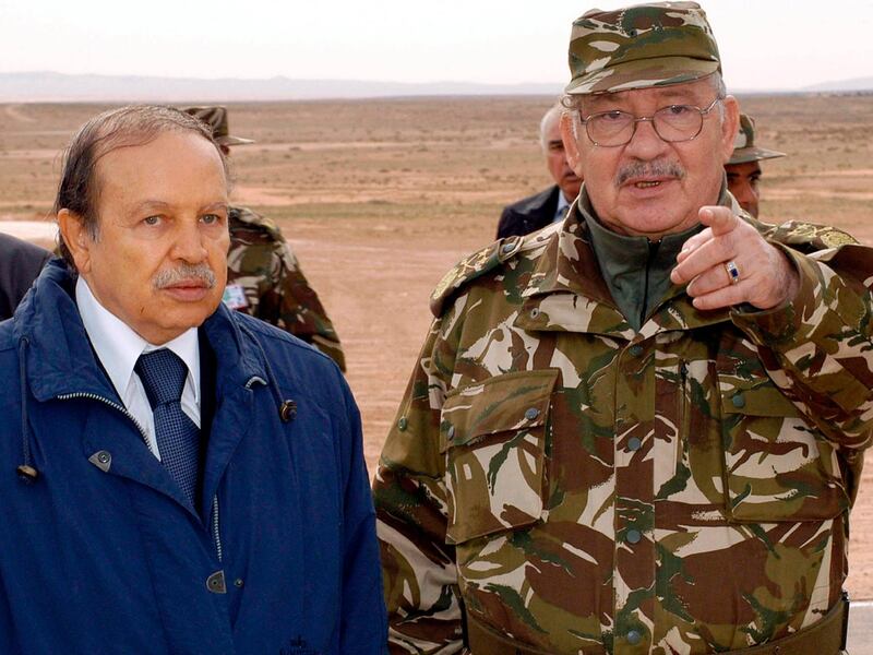 Gen Gaid Salah, right, gestures as he speaks with former Algerian President Abdelaziz Bouteflika in Hassi Bahbah, Algeria, in 2005. AP Photo