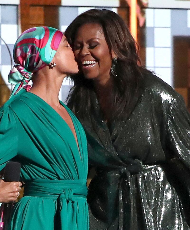 Alicia Keys, left, kisses Michelle Obama at the 61st annual Grammy Awards on Sunday, Feb. 10, 2019, in Los Angeles. (Photo by Matt Sayles/Invision/AP)