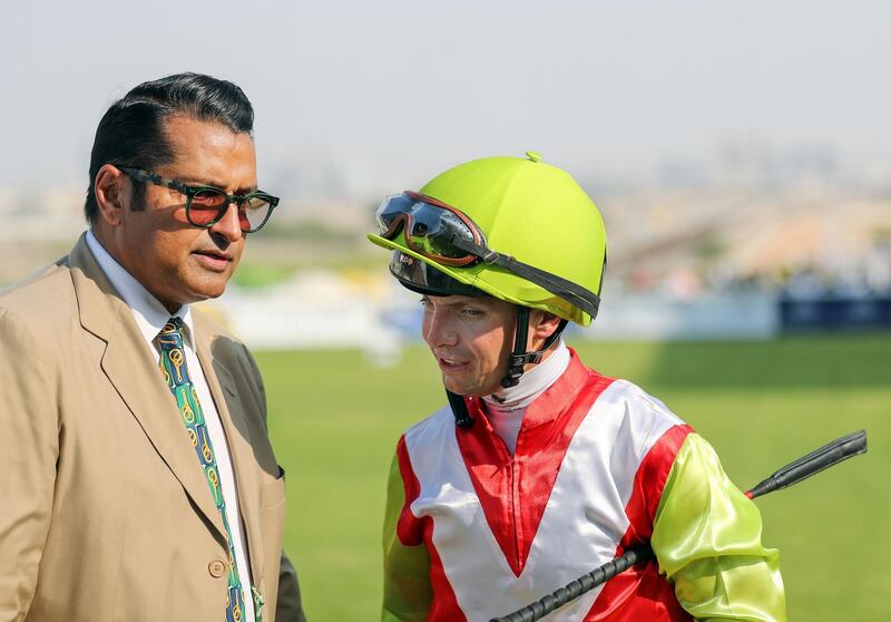 Dubai, United Arab Emirates - November 01, 2019: Trainer Satish Seemar (L) after his horse Night Castle ridden by Connor Beasley (R) wins the Al Shafar Investment race on the opening meeting at Jebel Ali racecourse. Friday the 1st of November 2019. Jebel Ali racecourse, Dubai. Chris Whiteoak / The National