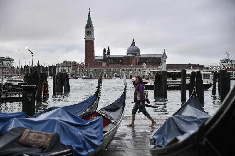 Stranded gondolas washed away at Riva degli Schiavoni, with the San Giorgio Maggiore basilica in the background. AFP