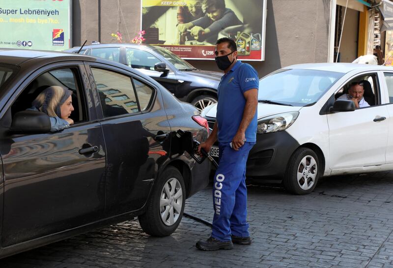 A petrol station worker fills up a customer's car in Beirut. The fuel crisis has also led to disruptions in vital infrastructure services, with more frequent power blackouts, water shortages and internet outages. Reuters