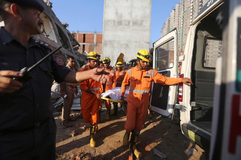 Rescue workers carry the body of a victim. AP Photo