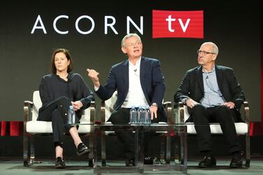 Philippa Braithwaite, Martin Clunes and chief content officer for Acorn brands, Mark Stevens on a panel promoting the TV show Manhunt. Shutterstock