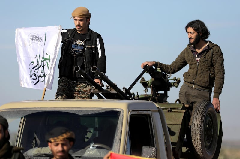 Turkish-backed Syrian rebels stand on the back of a truck at Manbij countryside, Syria December 29, 2018. REUTERS/Khalil Ashawi