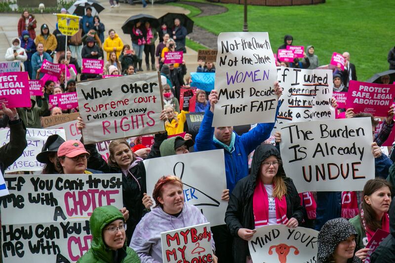 Protesters gather at the steps of the Michigan State Capitol in Lansing during a rally organised by Planned Parenthood. The Grand Rapids Press via AP
