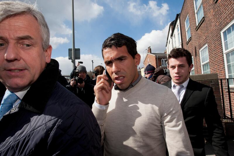 Manchester City footballer Carlos Tevez, center, leaves Macclesfield Magistrates Court, Macclesfield, England, Wednesday, April 3, 2013. Tevez has been ordered to carry out 250 hours of community service after being charged with driving while disqualified and without insurance. The maximum penalty for the first of those offences is six months in jail. The Argentina striker was allegedly at the wheel of a white Porsche Cayenne when he was stopped by police on March 7. (AP Photo/Jon Super) *** Local Caption ***  Britain Soccer Carlos Tevez.JPEG-0f369.jpg