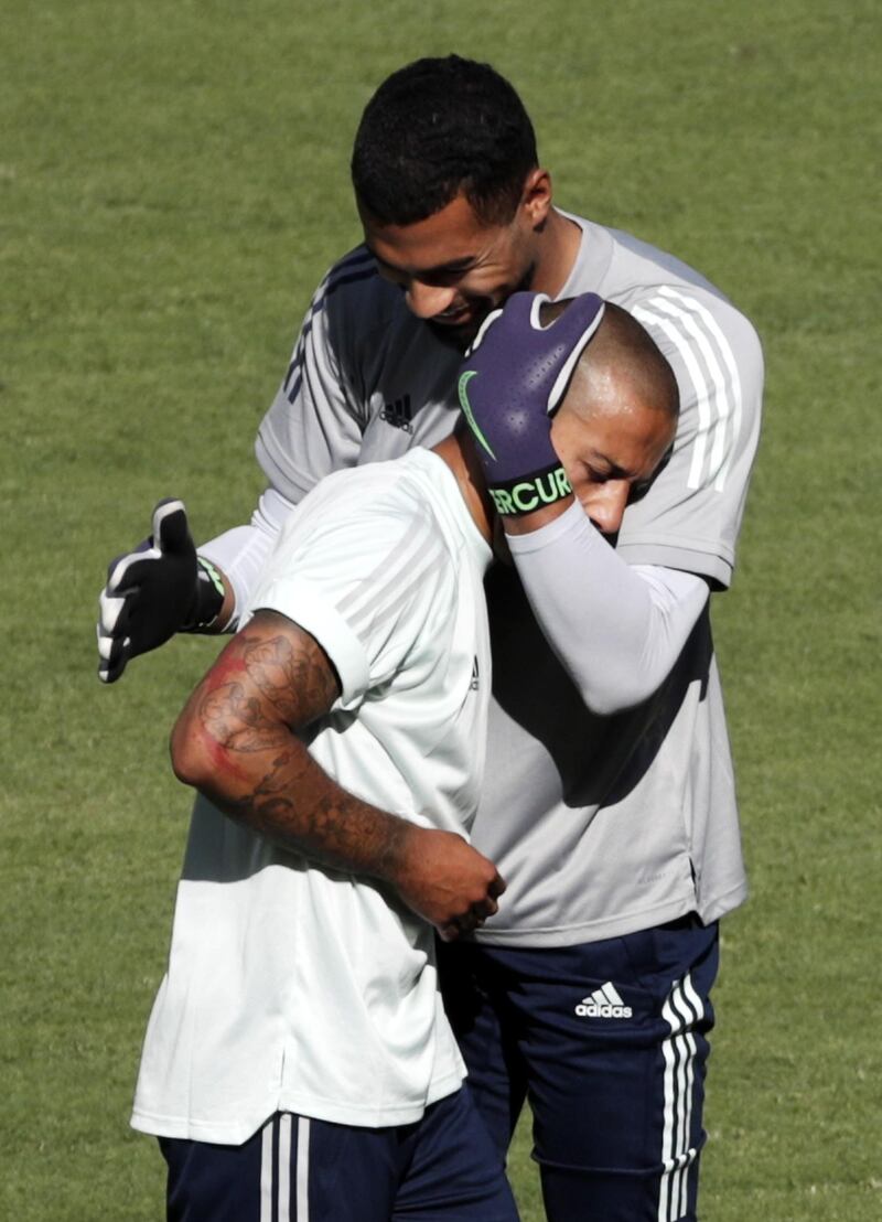 Spanish goalkeeper Robert Sanchez hugs teammate Thiago Alcantara in a training session at La Cartuja Stadium in Sevilla. EPA