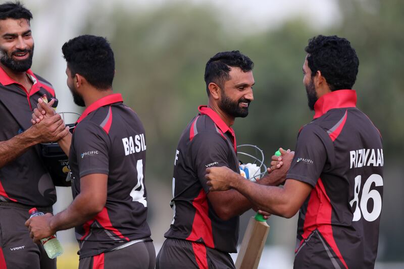UAE players celebrate their three-wicket victory.
