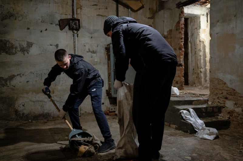 Residents clean a bomb shelter under an out-of-service cinema in central Zhytomyr. Reuters