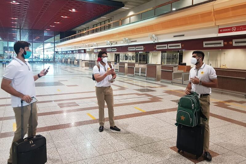 Pakistani cricketers Babar Azam, right, Imad Wasim, left, and Imam-ul-Haq at the Allama Iqbal International airport in Lahore on Sunday before their departure to England. AFP/PCB
