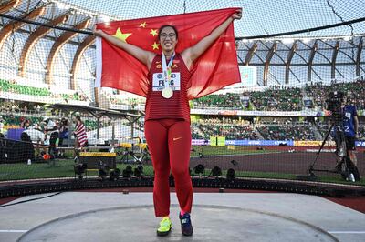 Feng Bin celebrates after winning the women's discus throw final. AFP