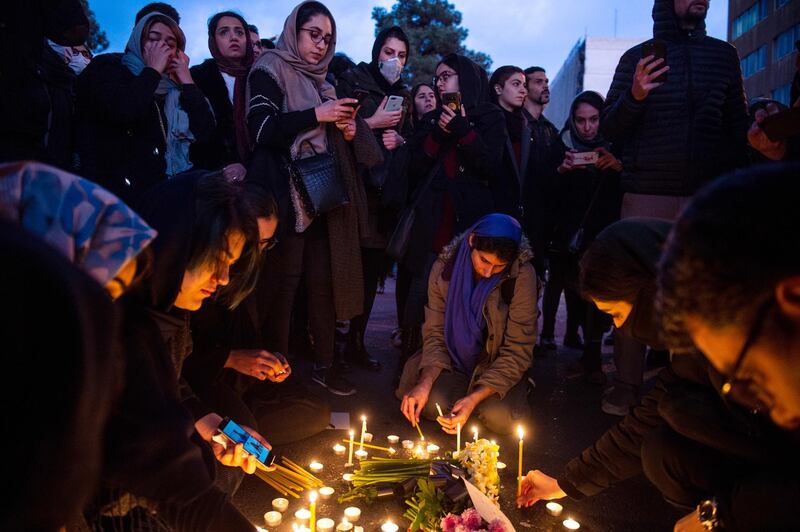 Demonstrators light candles while gathering during a vigil for the victims of the Ukraine International Airlines flight that was shot down by Iran, in Tehran, Iran, on Saturday, January 11. Bloomberg