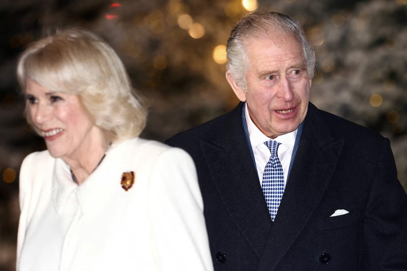 Britain's Queen Consort Camilla, left, and Britain's King Charles III arrive to attend the 'Together At Christmas Carol Service' at Westminster Abbey in London. AFP