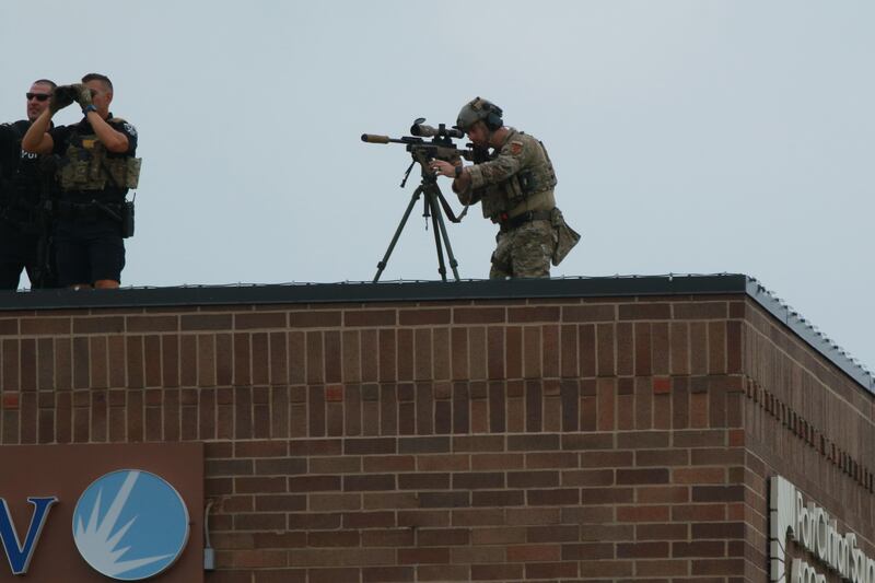 Officers keep a watchful eye following the shooting. AFP