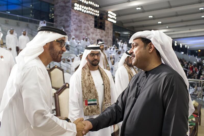 Sheikh Mohammed bin Zayed, Crown Prince of Abu Dhabi and Deputy Supreme Commander of the UAE Armed Forces, left, greets singer Mehad Hamad Al Muhairi, right. Also present are Sheikh Hamdan bin Zayed Al Nahyan, Deputy Prime Minister and Ruler of the Western Region, back centre. Ryan Carter / Crown Prince Court - Abu Dhabi