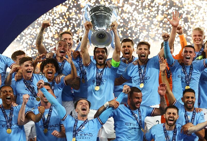 Manchester City's Ilkay Gundogan lifts the trophy as he celebrates with teammates after winning the Champions League. Reuters