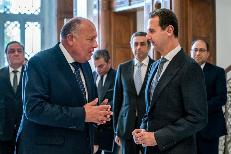 Sameh Shoukry speaks to Syrian President Bashar Al Assad during his visit to Damascus. AFP