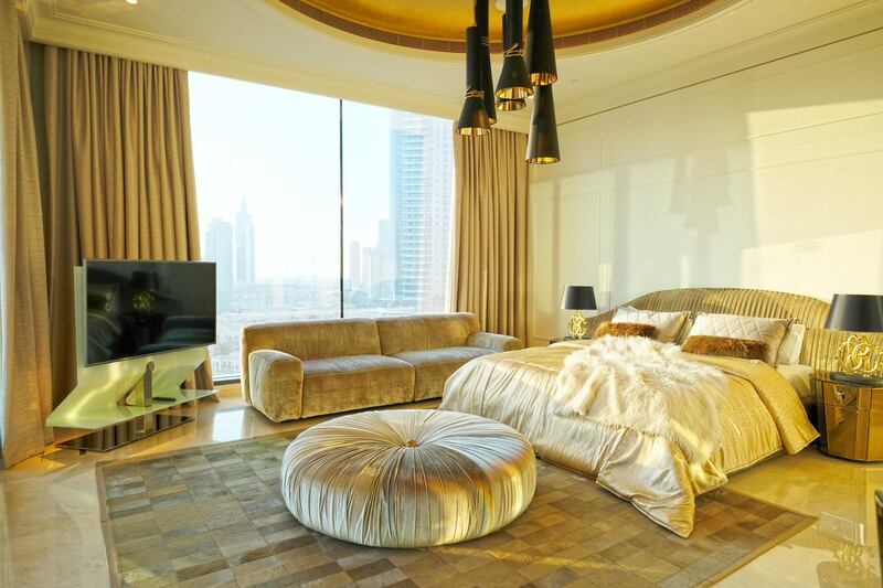 <p>A bedroom in the Classic apartment, which has oversized lights and burnished gold interiors&nbsp;</p>
