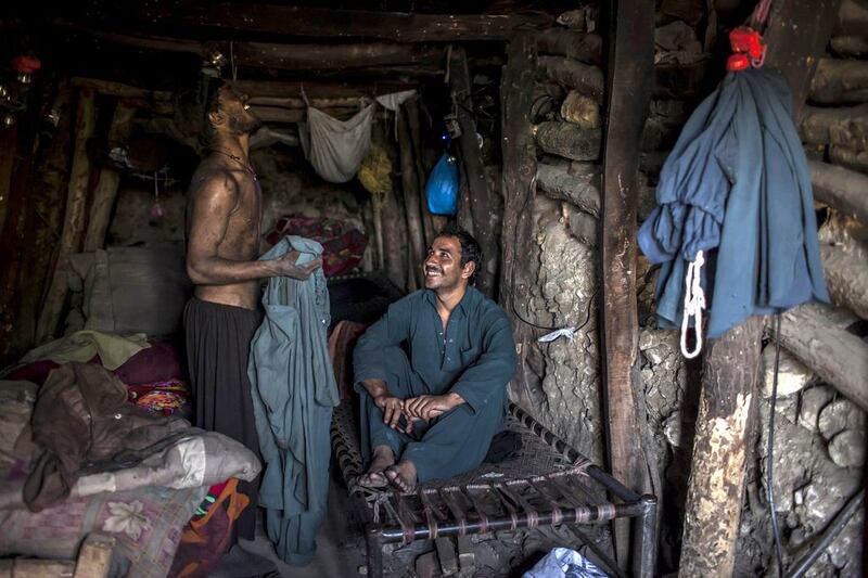 Miners rest in their rooms at the end of the day at a coal field in Choa Saidan Shah, Punjab. Sara Farid / Reuters