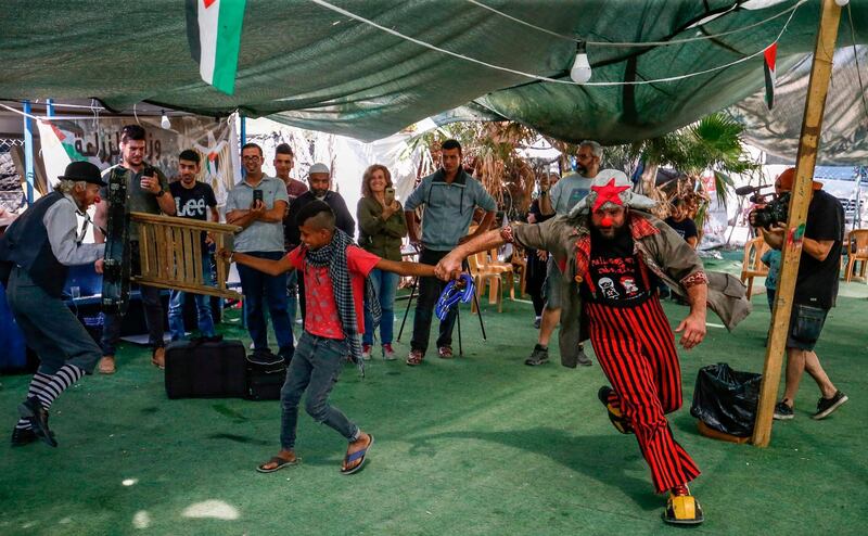 A troupe of Spanish clowns perform for children in the Palestinian Bedouin village of Khan al-Ahmar, east of Jerusalem, in the occupied West Bank. AFP