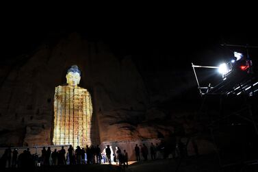 People watch a three-dimensional projection of the 56-metre Salsal Buddha on Tuesday, at the site where the Buddhas of Bamiyan statues stood before being destroyed by the Taliban in March 2001, in Bamiyan province, Afghanistan. AFP