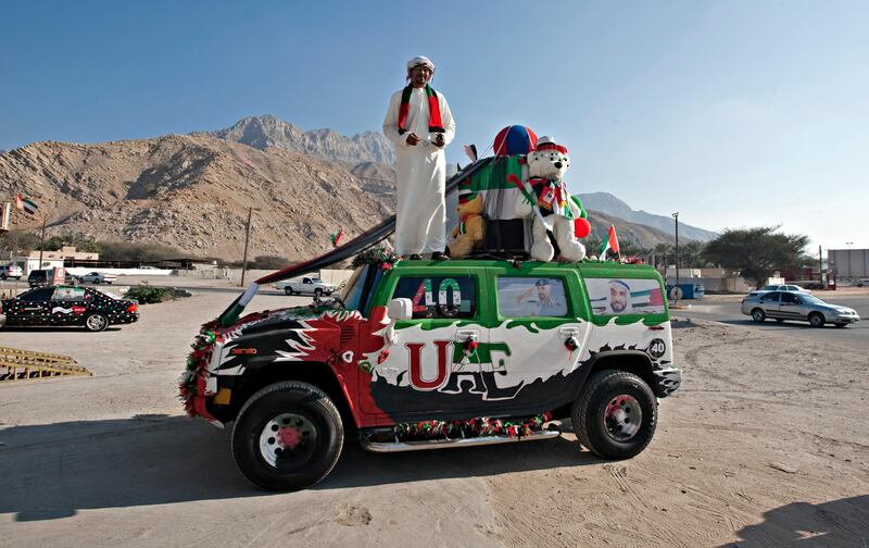 Ras al Khaimah, December 2, 2011 - Police officer Theyab Abdullah, 28, and four others spent a week and 2,000 AED decorating his 2005 Hummer H2 for the National Day celebrations in Ras al Khaimah, December 2, 2011. Abdullah received a 200 AED fine for decorative car violations but said, "It's a problem for the police. Every day he stops me and he says, 'what is this?' I don't know what I can say to him. I say, 'OK, no problem'. If he says to me 'pay Dh1,000' I pay but I will not take it off because that's my day, that's my country, you know, I don't care. It's OK, he said outside a market in Al Jeer, Ras al Khaimah. (Jeff Topping/The National)