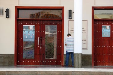 A man prays outside a mosque in Dubai Investment Park. Places of worship were closed to the public in mid-March to stop the spread of coronavirus but will reopen on July 1. Chris Whiteoak / The National