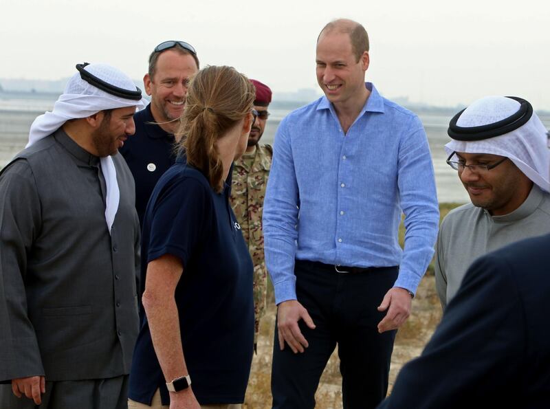 Britain's Duke of Cambridge Prince William (second right) and director of Kuwait's environment public authority Sheikh Abdullah Ahmad Al-Humoud Al-Sabah (L) talk to the staff at Jahra Pools nature reserve, 35km north of the Kuwaiti capital, during a beach cleaning operation. AFP